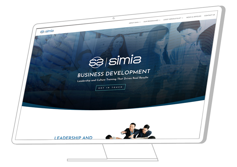 Simia Business Development website shown on a monitor